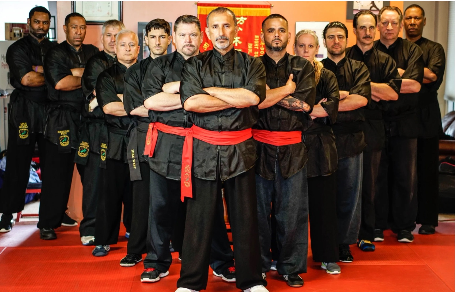 Sifu Raul Ortiz and OCBA instructors in black uniforms with red sashes